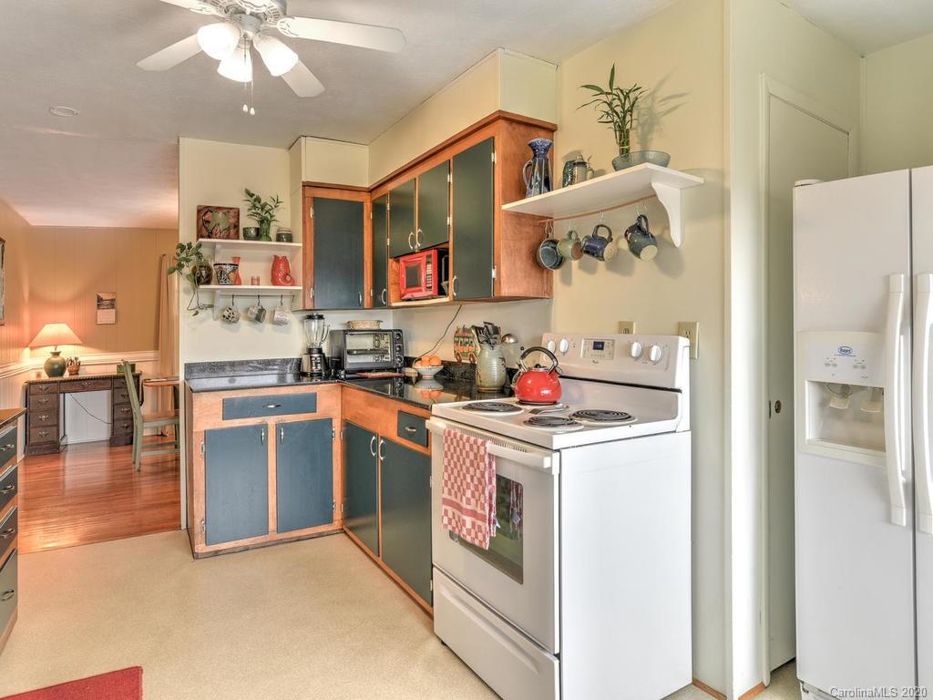 48 Rainbow Ridge Road Leicester, NC 28748 - Photo 14 of 39 a kitchen with granite countertop a white stove top oven and cabinets