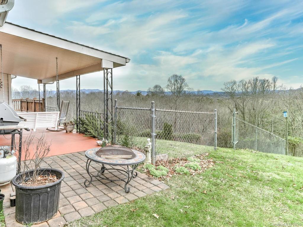 48 Rainbow Ridge Road Leicester, NC 28748 - Photo 22 of 39 a backyard of a house with fountain table and chairs