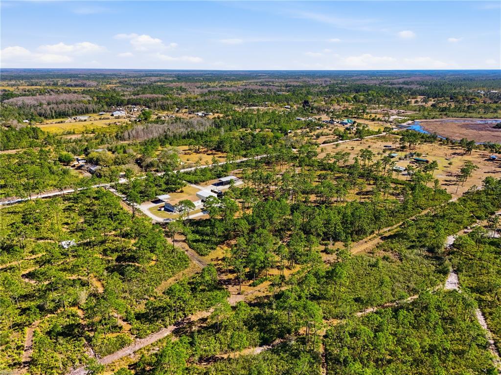 6844 Chad Jason Road St. Cloud, FL 34773 - Photo 57 of 59 an aerial view of residential houses with outdoor space and trees