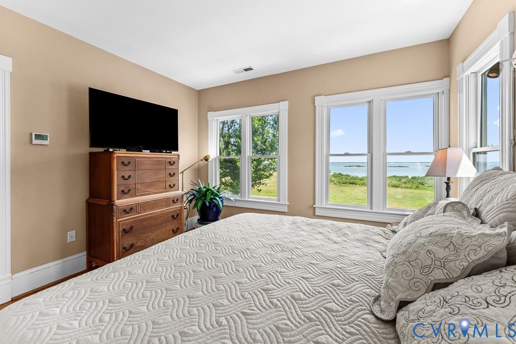 2414 Windmill Point Road White Stone, VA 22578 - Photo 28 of 72 a bedroom with a bed and a flat screen tv
