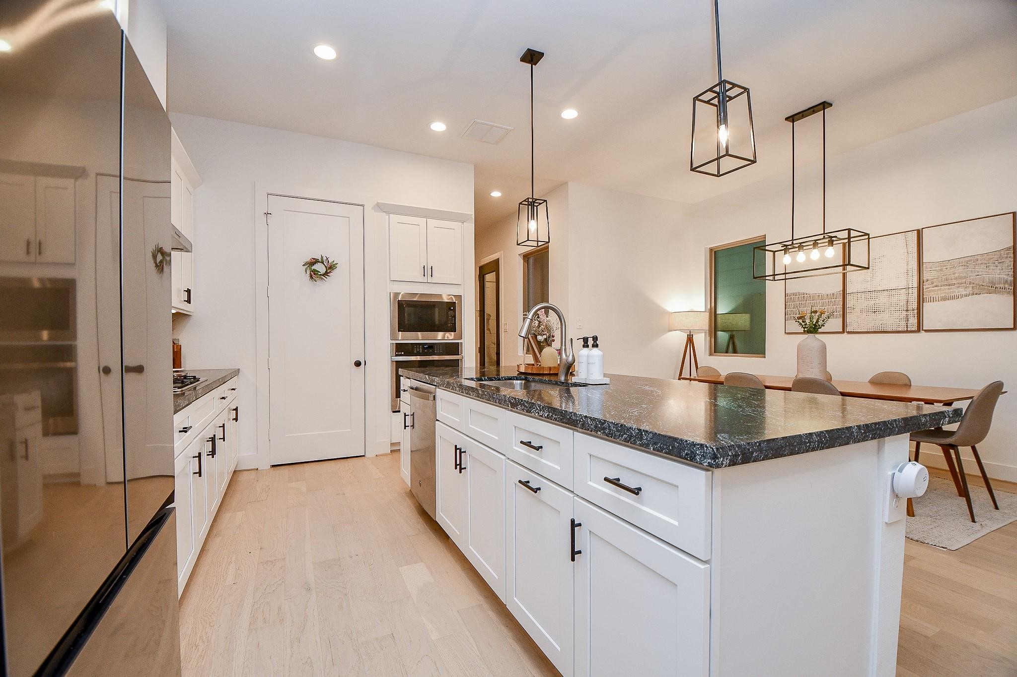 4403 Greeley Street Houston, TX 77006 - Photo 8 of 28 a kitchen with stainless steel appliances granite countertop a sink and refrigerator