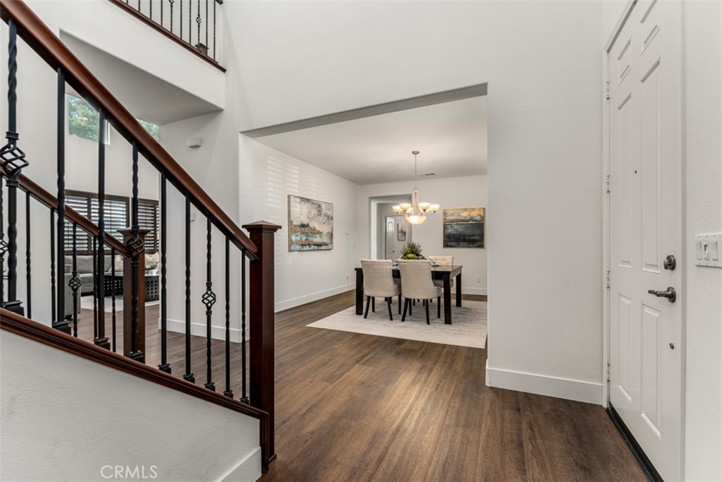 14977 Brooktree Street Eastvale, CA 92880 - Photo 12 of 34 a view of dining room with hardwood floor and furniture
