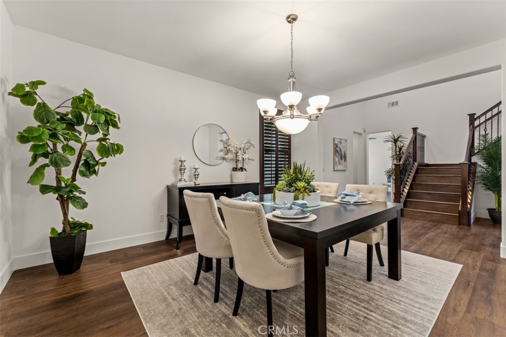 14977 Brooktree Street Eastvale, CA 92880 - Photo 13 of 34 a view of a dining room with furniture and wooden floor