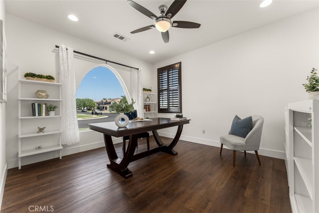 14977 Brooktree Street Eastvale, CA 92880 - Photo 15 of 34 a view of a workspace with furniture and a wooden floor