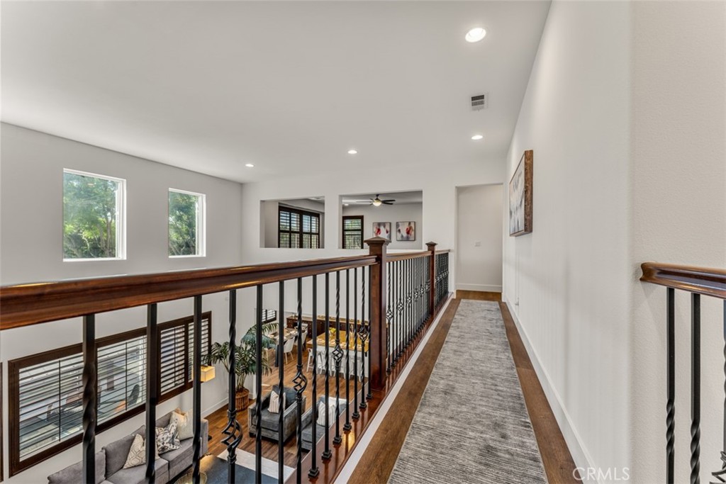 14977 Brooktree Street Eastvale, CA 92880 - Photo 16 of 34 a view of a hallway with wooden floor and staircase