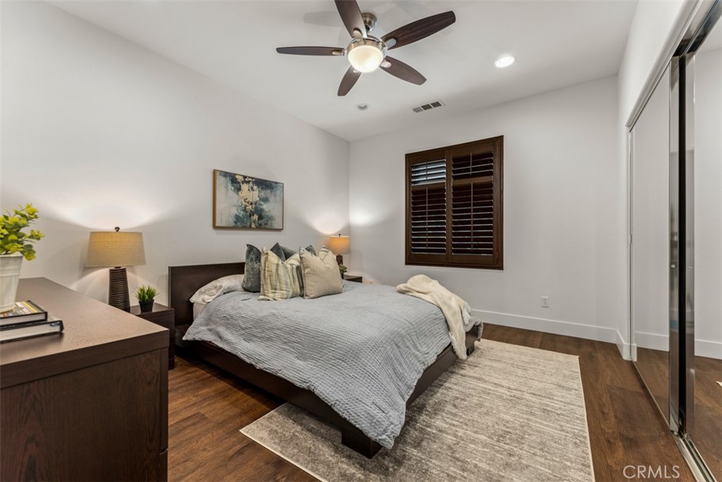 14977 Brooktree Street Eastvale, CA 92880 - Photo 32 of 34 a bedroom with a bed and a chandelier