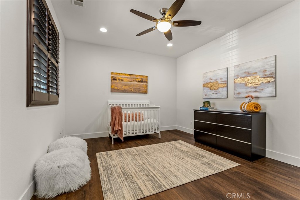 14977 Brooktree Street Eastvale, CA 92880 - Photo 33 of 34 a bedroom with furniture and a window