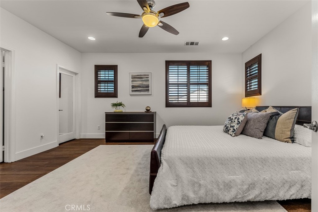 14977 Brooktree Street Eastvale, CA 92880 - Photo 20 of 34 a bedroom with a bed and a window