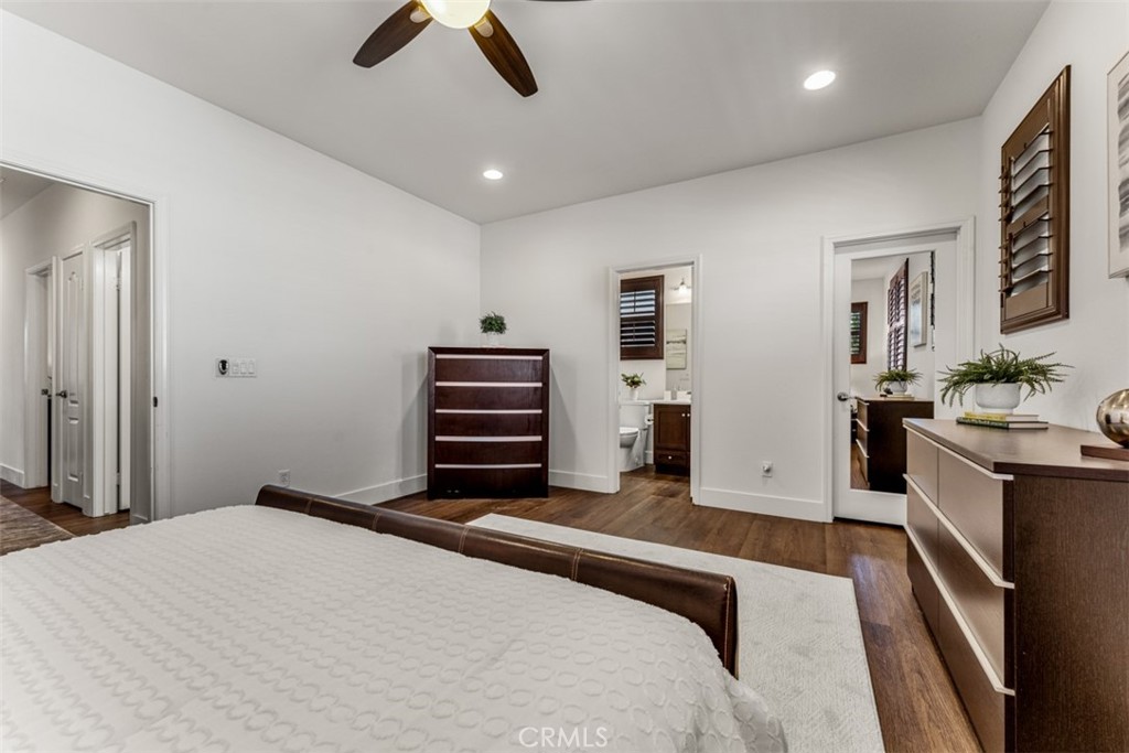 14977 Brooktree Street Eastvale, CA 92880 - Photo 34 of 34 a bedroom with a bed and a chandelier