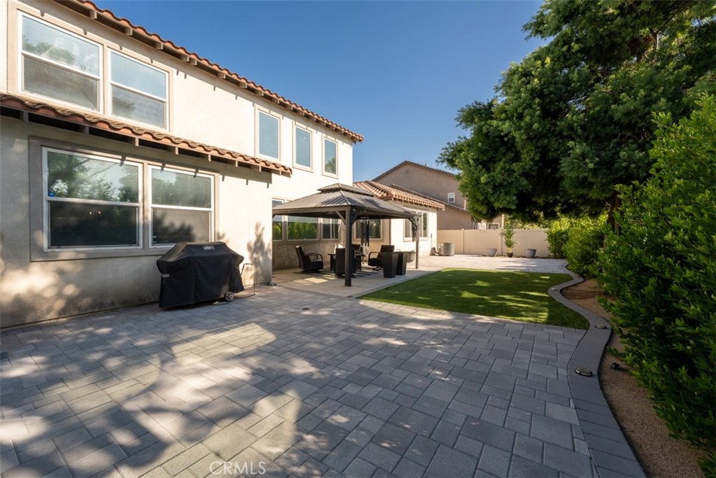14977 Brooktree Street Eastvale, CA 92880 - Photo 22 of 34 a view of a house with backyard and sitting area
