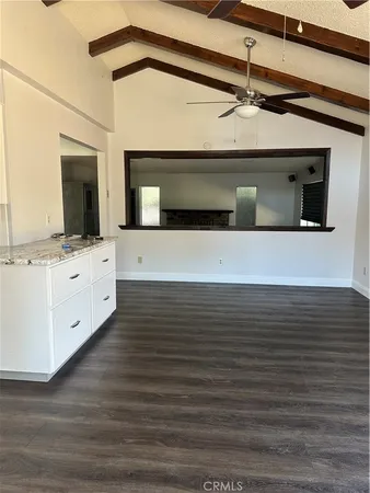 a view of kitchen with stainless steel appliances wooden floor