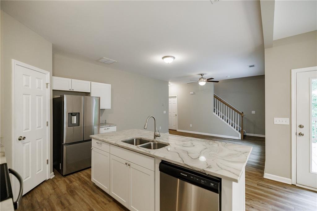 103 Three Rivers Court Hull, GA 30646 - Photo 15 of 40 a kitchen with granite countertop a sink and refrigerator