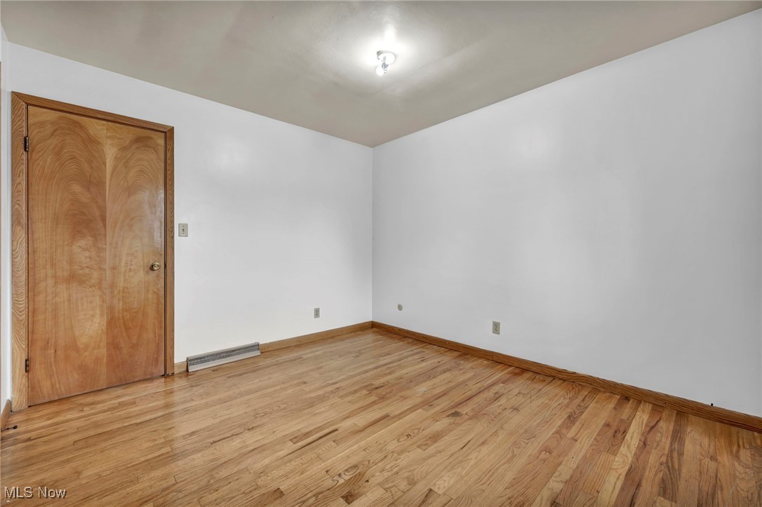1140 Keefer Road Girard, OH 44420 - Photo 28 of 49 Unfurnished room with light wood-style flooring and a baseboard radiator