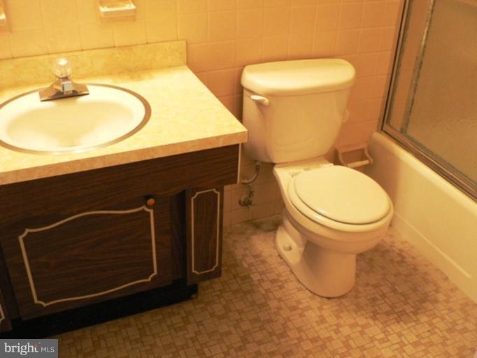1111 University Boulevard West, Unit 413A Silver Spring, MD 20902 - Photo 2 of 14 a bathroom with a sink and a toilet