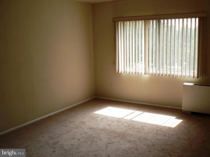 1111 University Boulevard West, Unit 413A Silver Spring, MD 20902 - Photo 12 of 14 an empty room with a window