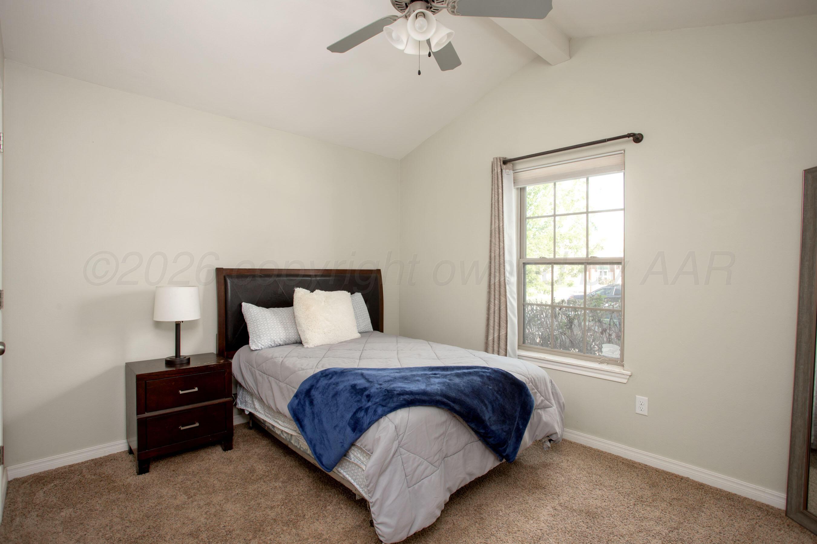 9505 Perry Avenue Amarillo, TX 79119 - Photo 14 of 21 a bedroom with a bed and window