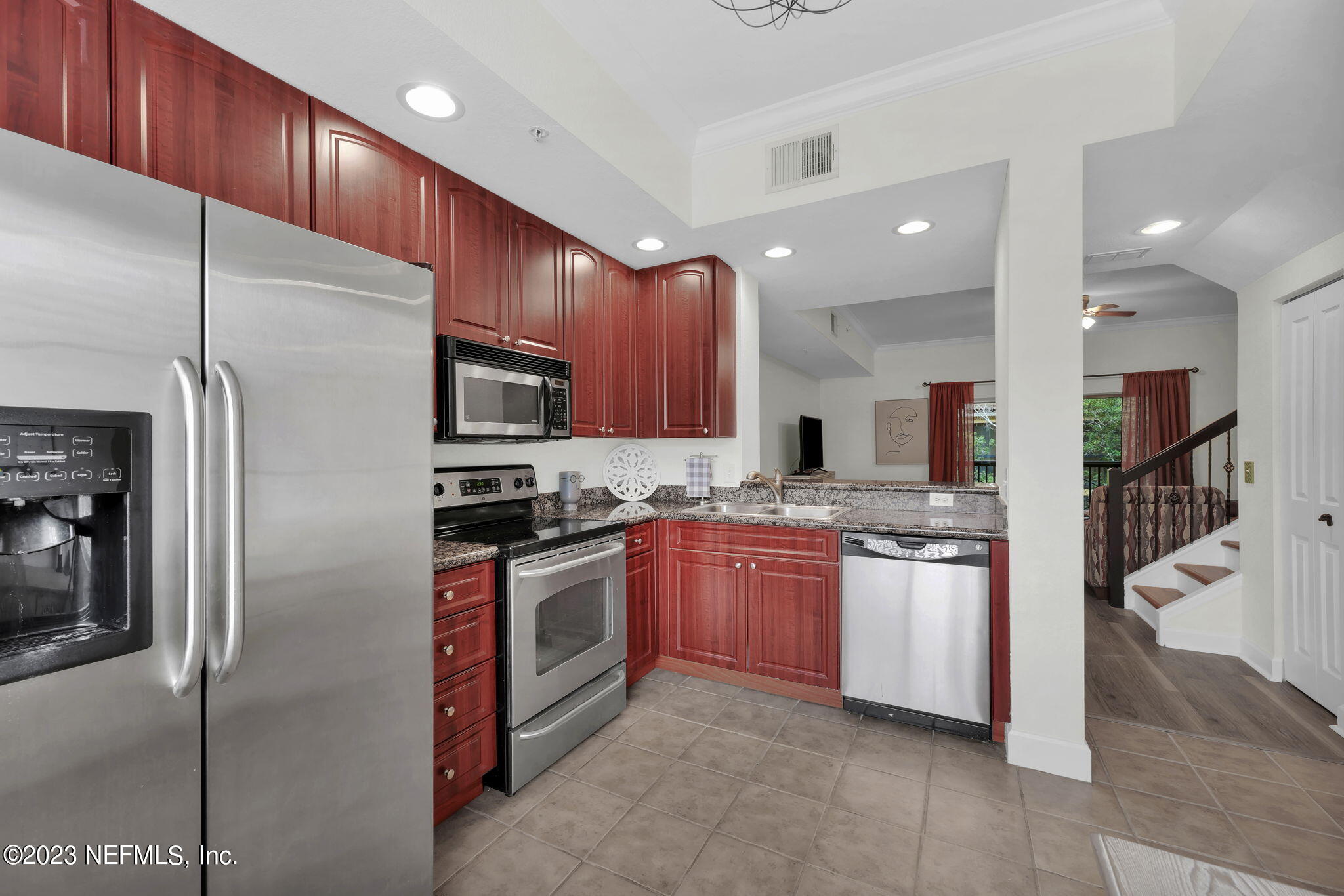 9745 Touchton Road, Unit 428 Jacksonville, FL 32246 - Photo 11 of 40 a kitchen with stainless steel appliances granite countertop a refrigerator a sink and a stove