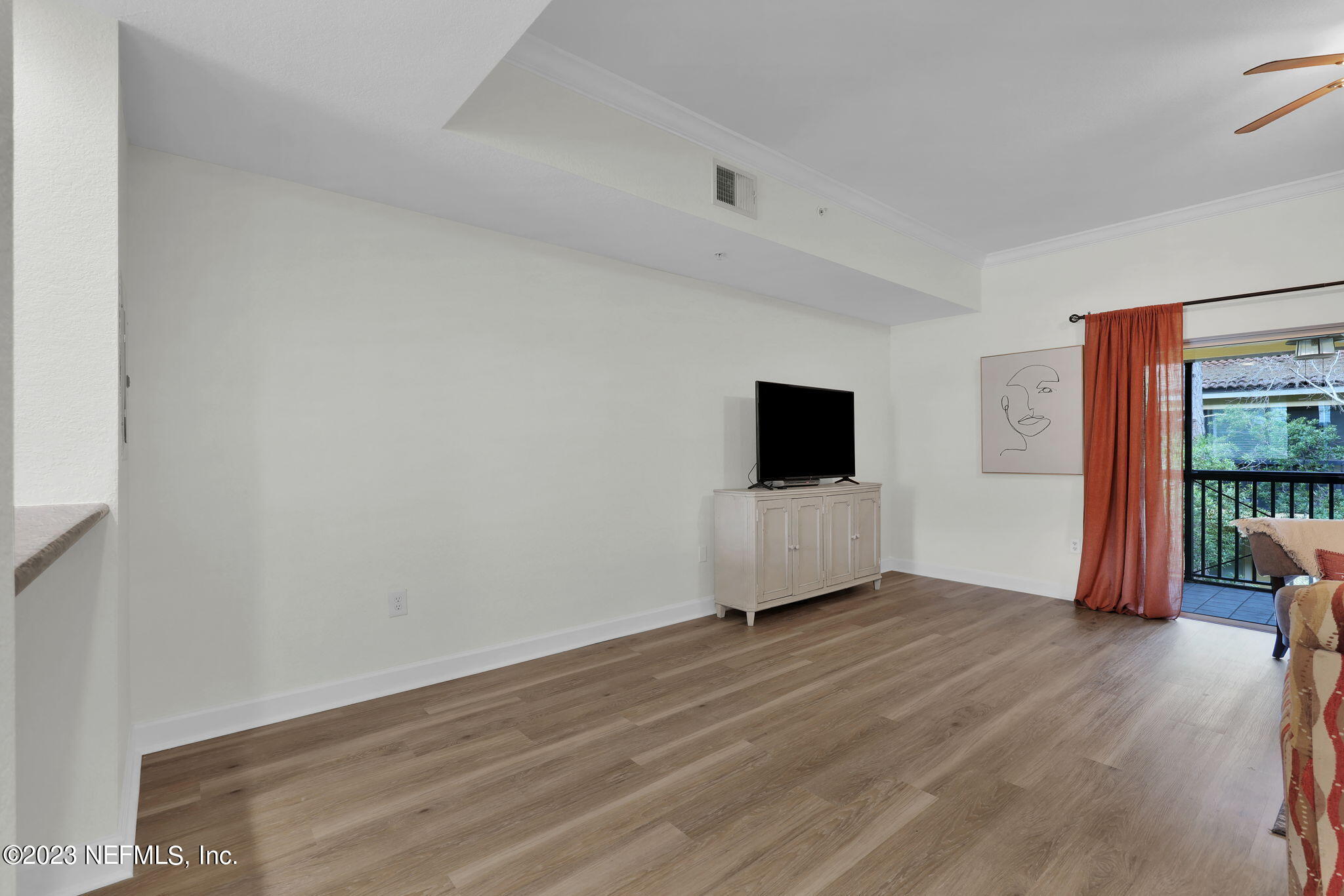 9745 Touchton Road, Unit 428 Jacksonville, FL 32246 - Photo 14 of 40 an empty room with wooden floor and windows