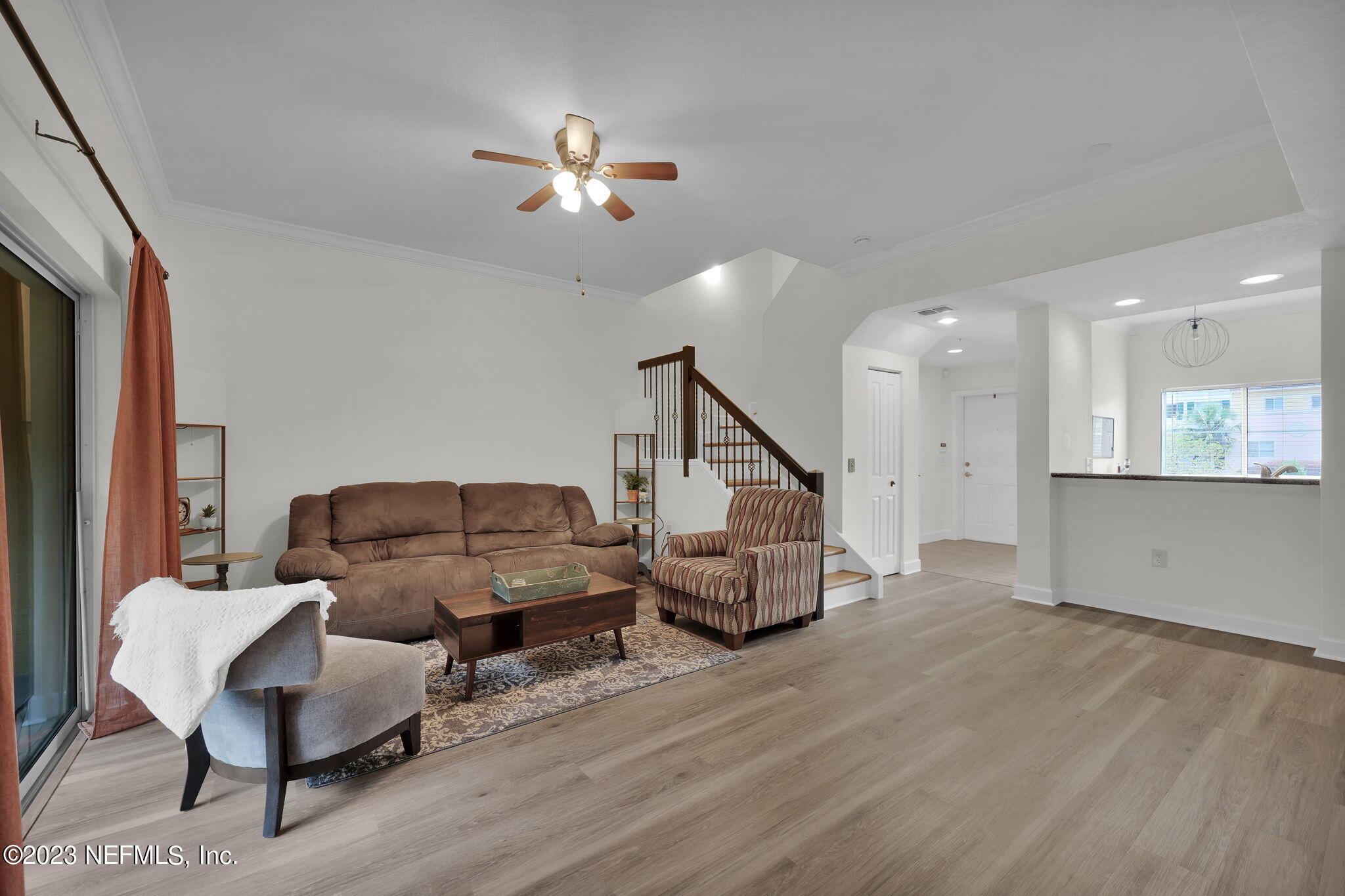 9745 Touchton Road, Unit 428 Jacksonville, FL 32246 - Photo 16 of 40 a living room with furniture and wooden floor