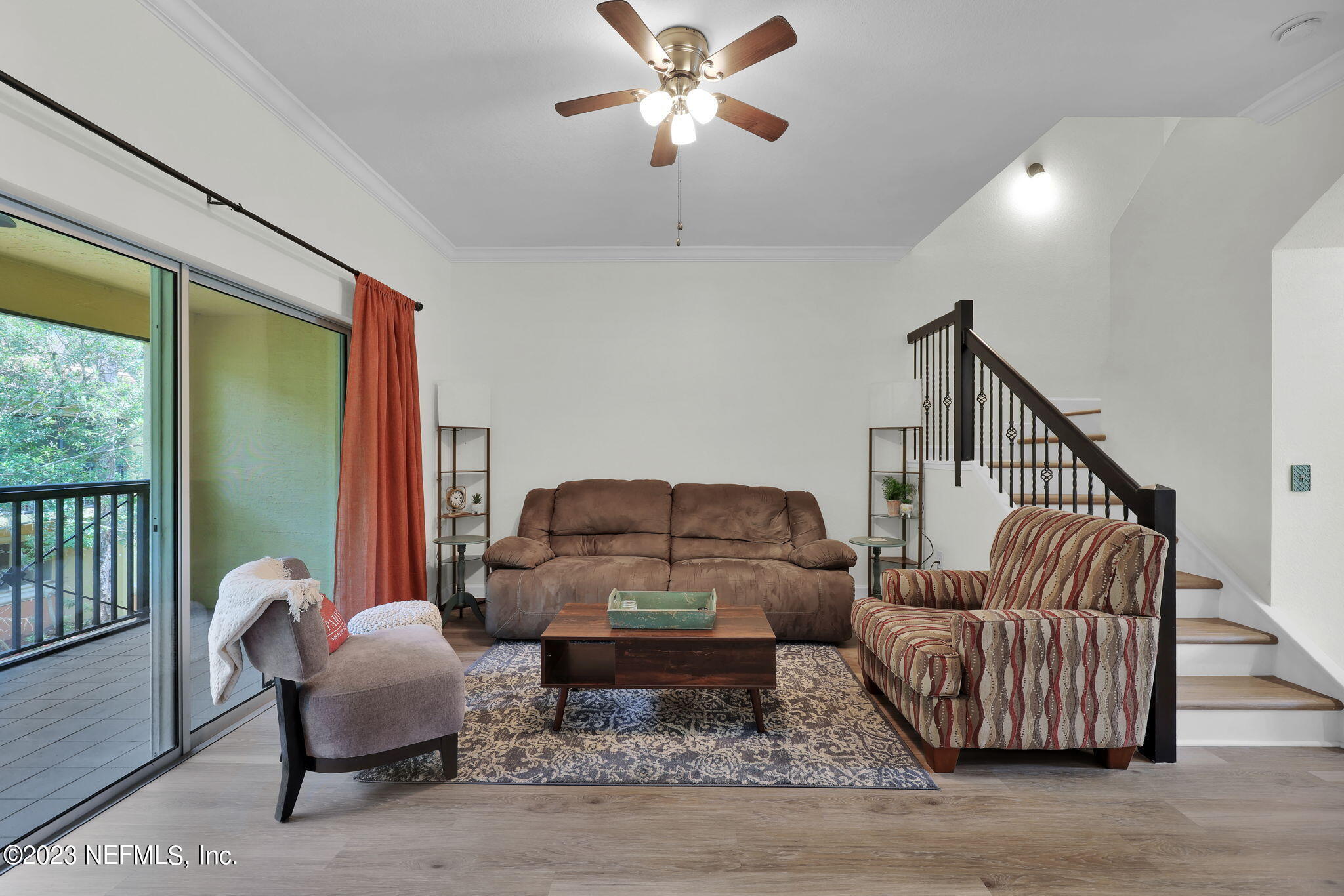 9745 Touchton Road, Unit 428 Jacksonville, FL 32246 - Photo 18 of 40 a living room with furniture and a ceiling fan
