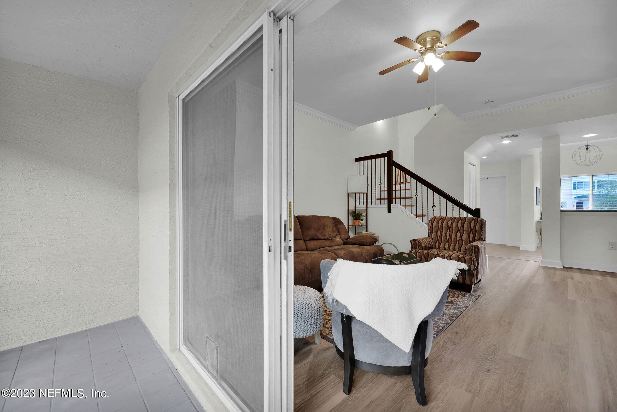 9745 Touchton Road, Unit 428 Jacksonville, FL 32246 - Photo 19 of 40 a living room with furniture and a chandelier