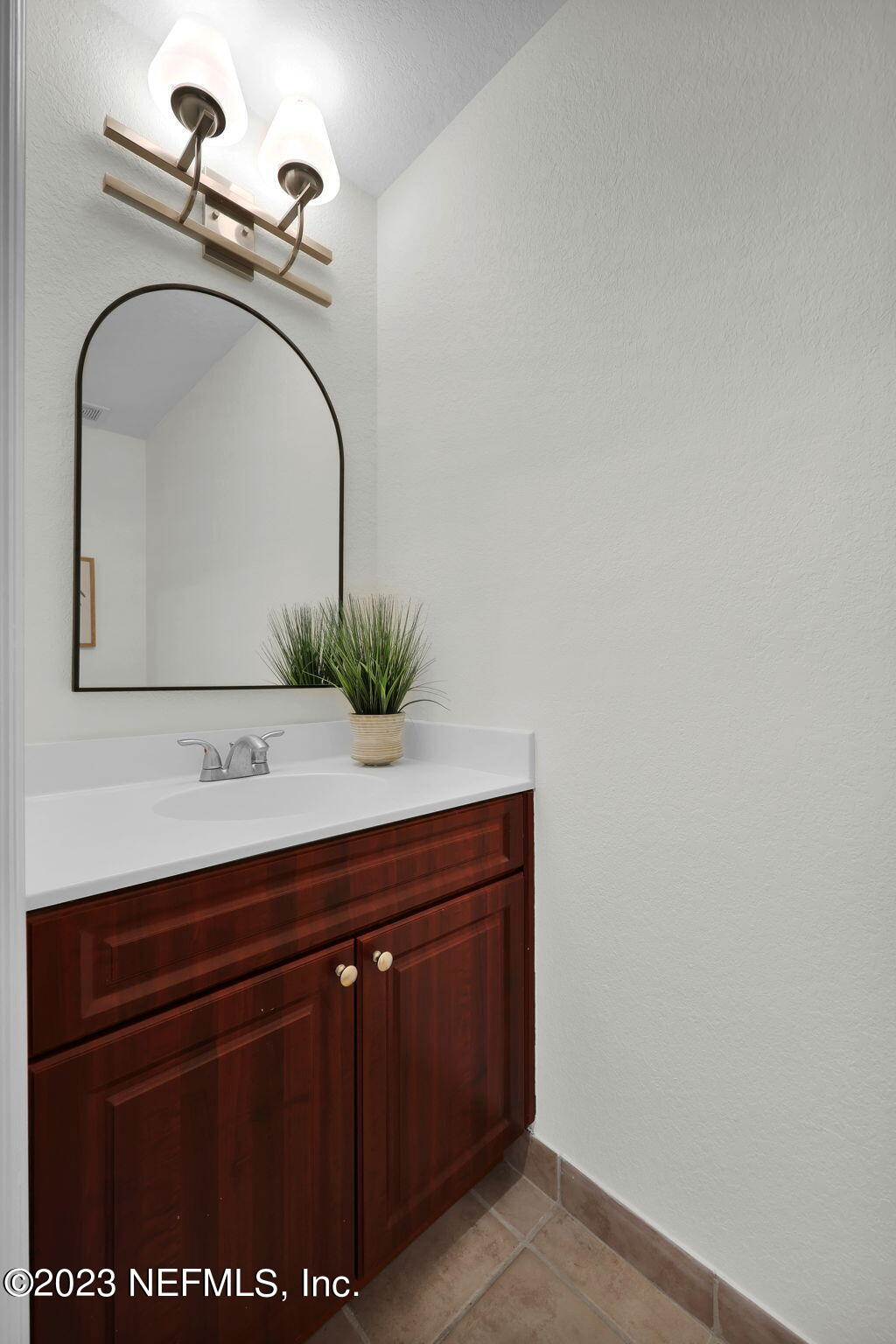 9745 Touchton Road, Unit 428 Jacksonville, FL 32246 - Photo 23 of 40 a bathroom with a sink and a mirror
