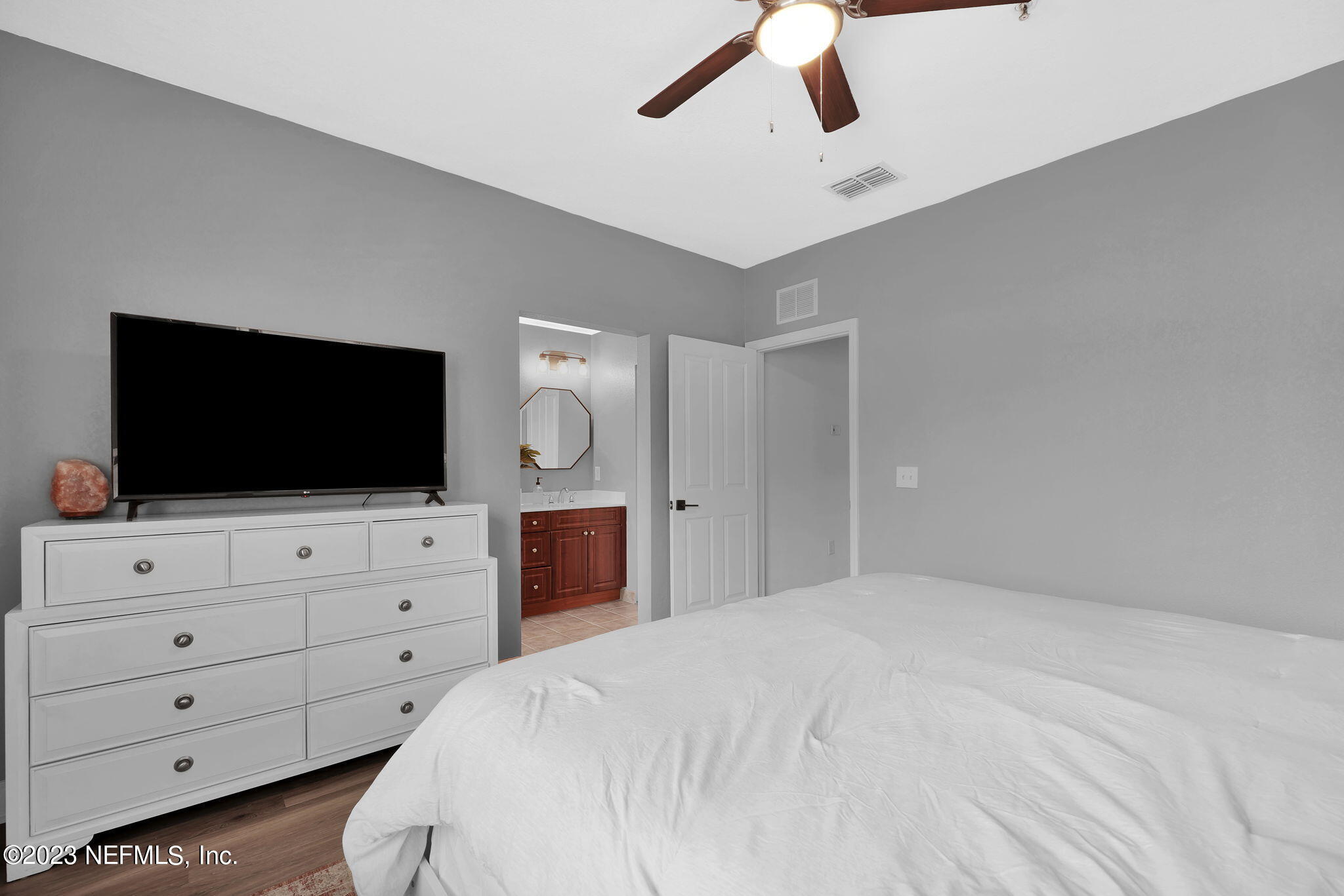 9745 Touchton Road, Unit 428 Jacksonville, FL 32246 - Photo 26 of 40 a bedroom with a bed and flat screen tv
