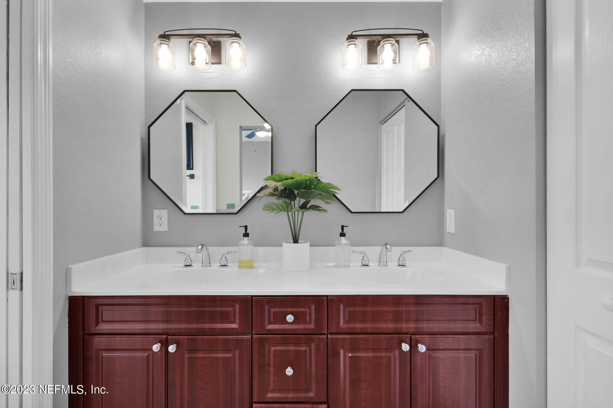 9745 Touchton Road, Unit 428 Jacksonville, FL 32246 - Photo 27 of 40 a bathroom with a sink and a mirror