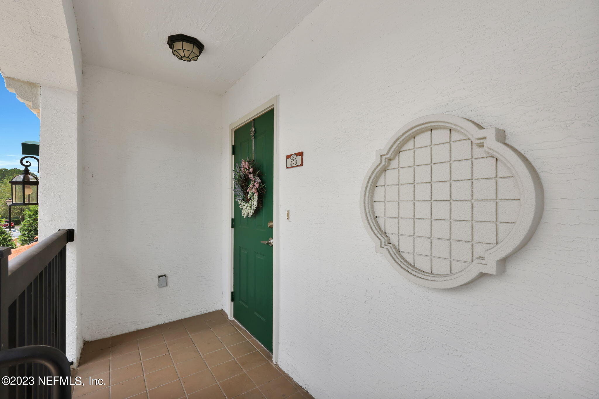 9745 Touchton Road, Unit 428 Jacksonville, FL 32246 - Photo 7 of 40 an entrance view with a large window and a potted plant