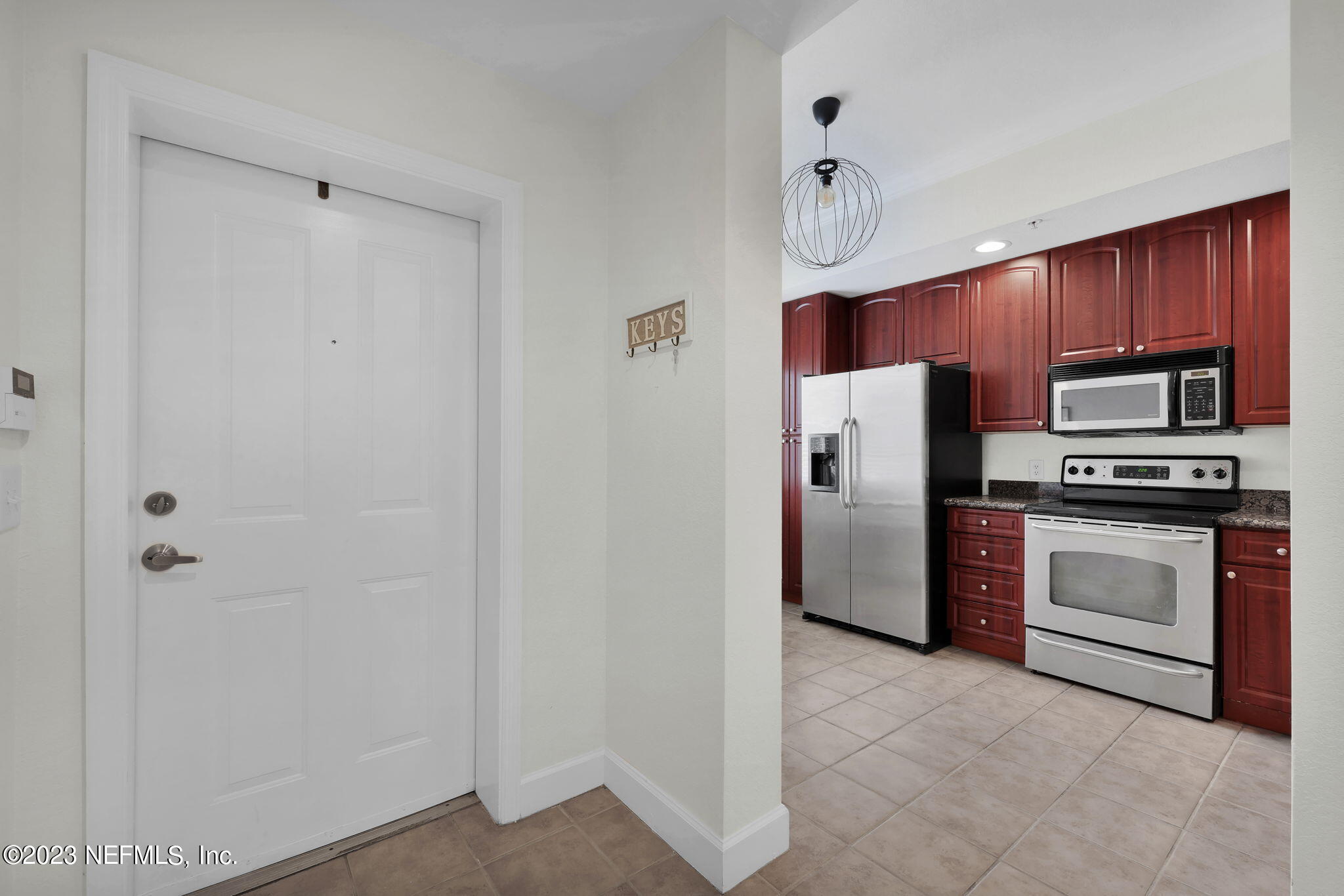 9745 Touchton Road, Unit 428 Jacksonville, FL 32246 - Photo 9 of 40 a kitchen with stainless steel appliances granite countertop a refrigerator and a stove top oven