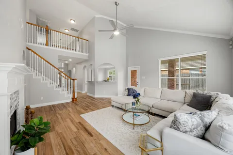 a living room with furniture and wooden floor