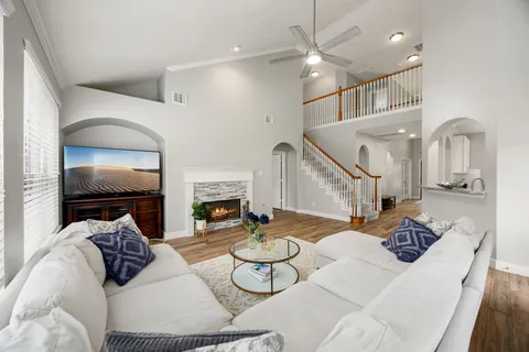 a living room with furniture a fireplace and a flat screen tv