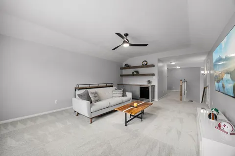 a living room with furniture and a fireplace