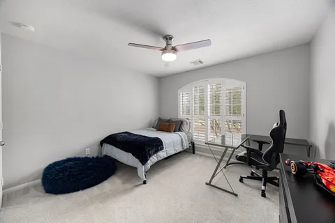 a bedroom with furniture and a window