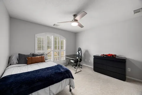 a bedroom with bed and window