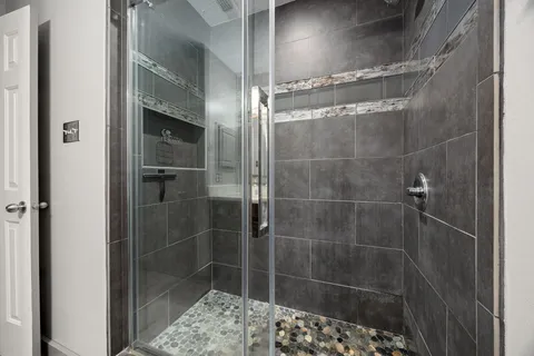 a bathroom with a glass shower door