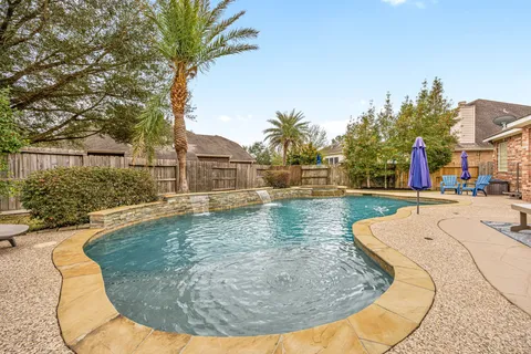a view of a swimming pool with a yard