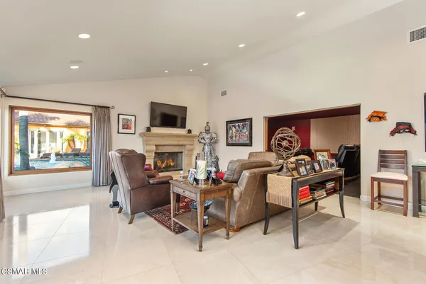 a dining room with stainless steel appliances granite countertop a dining table and chairs