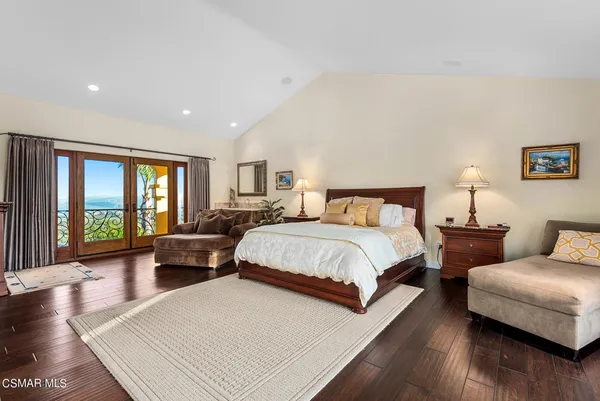 a spacious bedroom with a bed and a couch