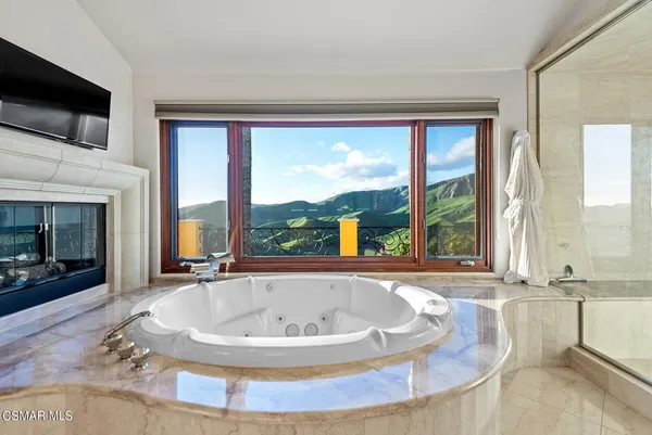 a large spacious bathroom with a large tub and sink