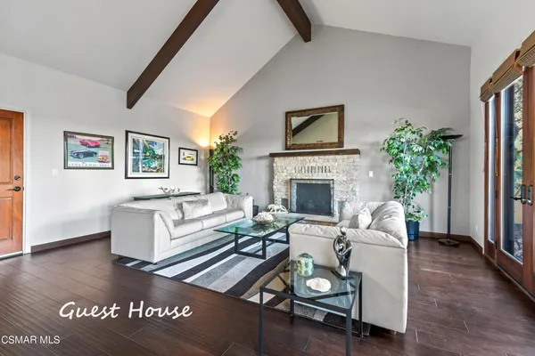 a bedroom with a bed and a flat tv screen on dresser