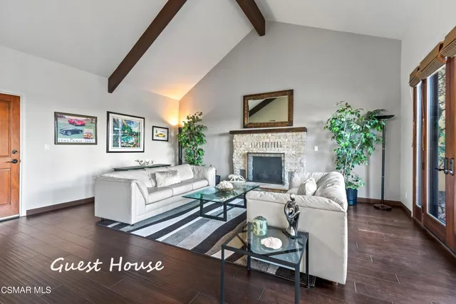 a bedroom with a bed and a flat tv screen on dresser