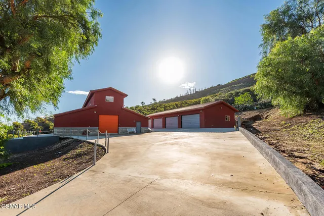 a backyard of a house with a fireplace