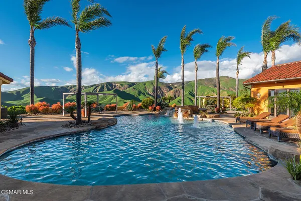 a view of swimming pool with garden and deck