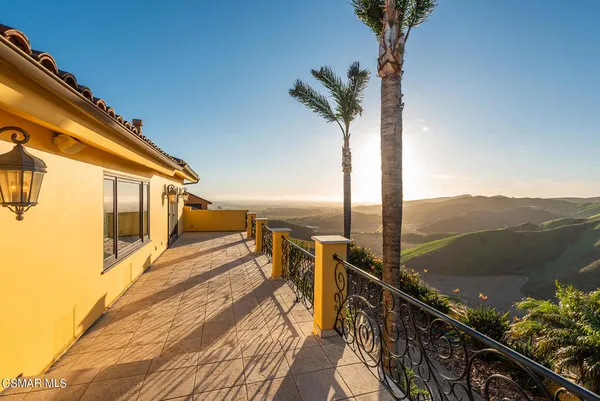 a view of a house with swimming pool and sitting area