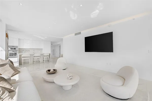 a bedroom with a large bed and a painting on the wall
