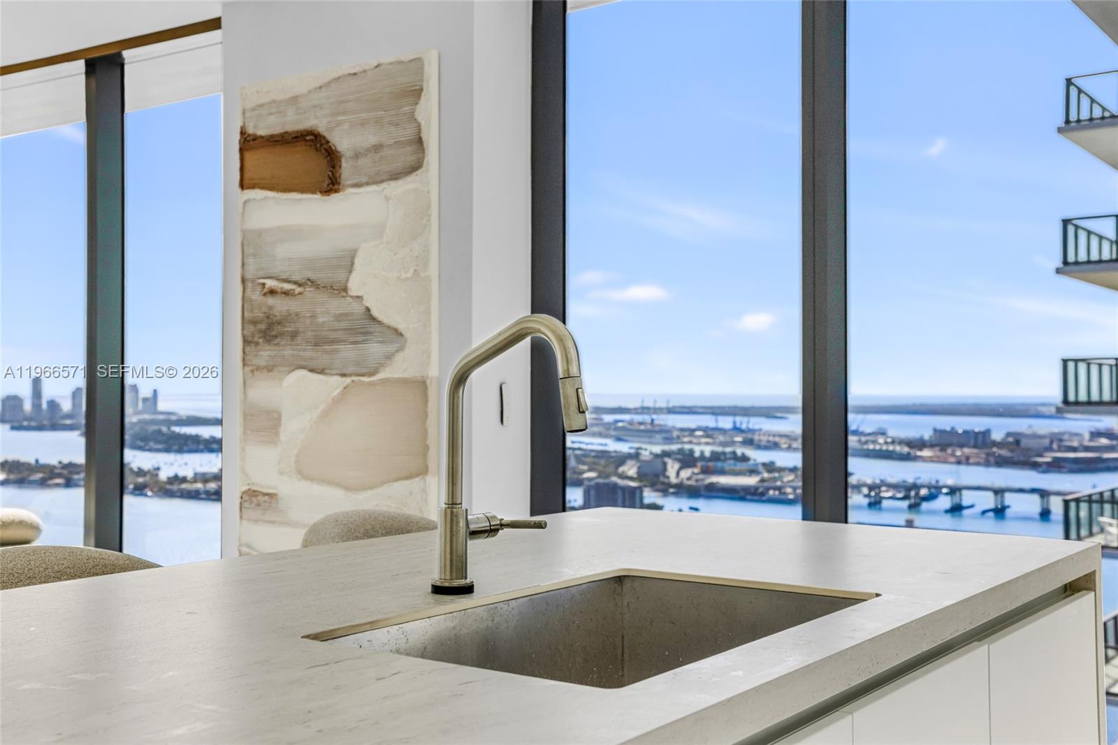 700 Northeast 24th Street, Unit 4007 Miami, FL 33137 - Photo 25 of 100 a view of a kitchen with a sink and living room