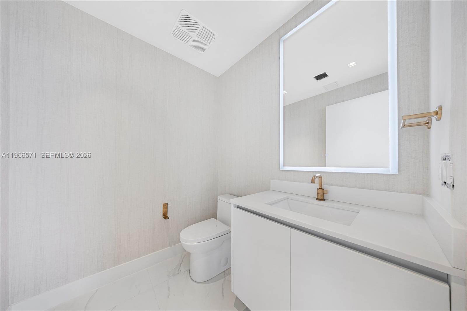 700 Northeast 24th Street, Unit 4007 Miami, FL 33137 - Photo 27 of 100 a bathroom with a sink and a toilet