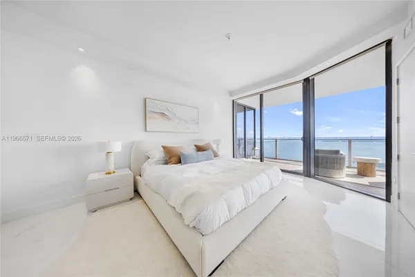 a bed room with a bed and a chair