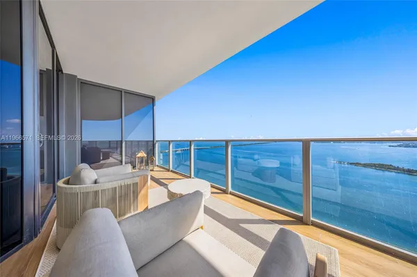 a living room with furniture tv and a large window